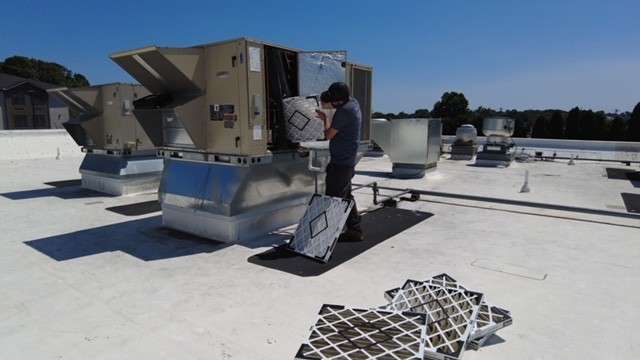 SS Service Corp technician performing commercial HVAC preventative maintenance