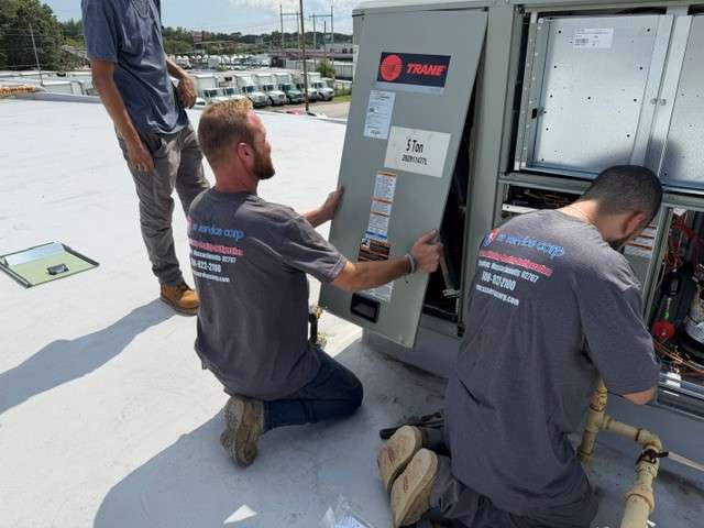 SS Service Corp technicians servicing commercial rooftop HVAC unit